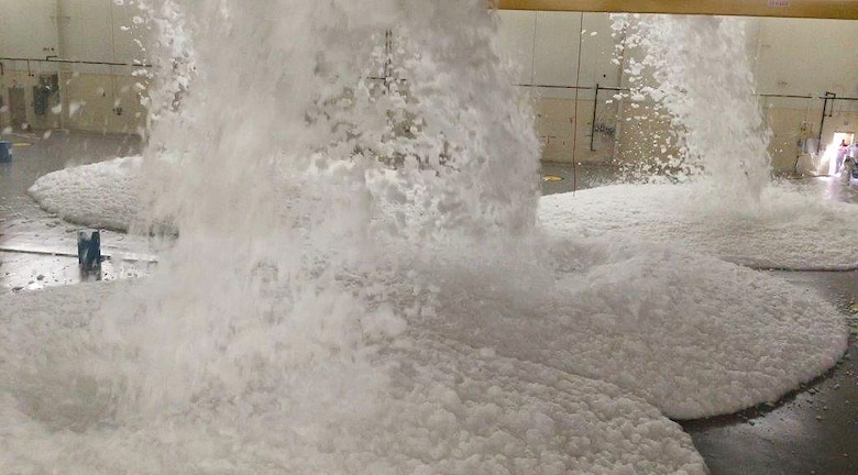 Workers conduct a live test of the Foam Fire Suppression System on the new Unmanned Aerial Systems hangar at Camp Mackall. The foam suppresses fire while saving the aircraft. The facility, built by Caddell Construction, won the state and national-level Associated Builders and Constractors, Inc. Excellence in Construction Competition in December 2016. It also received state-level honors from the Associated General Contractors of America. It will be home to the UAS MQ-1C Gray Eagle.