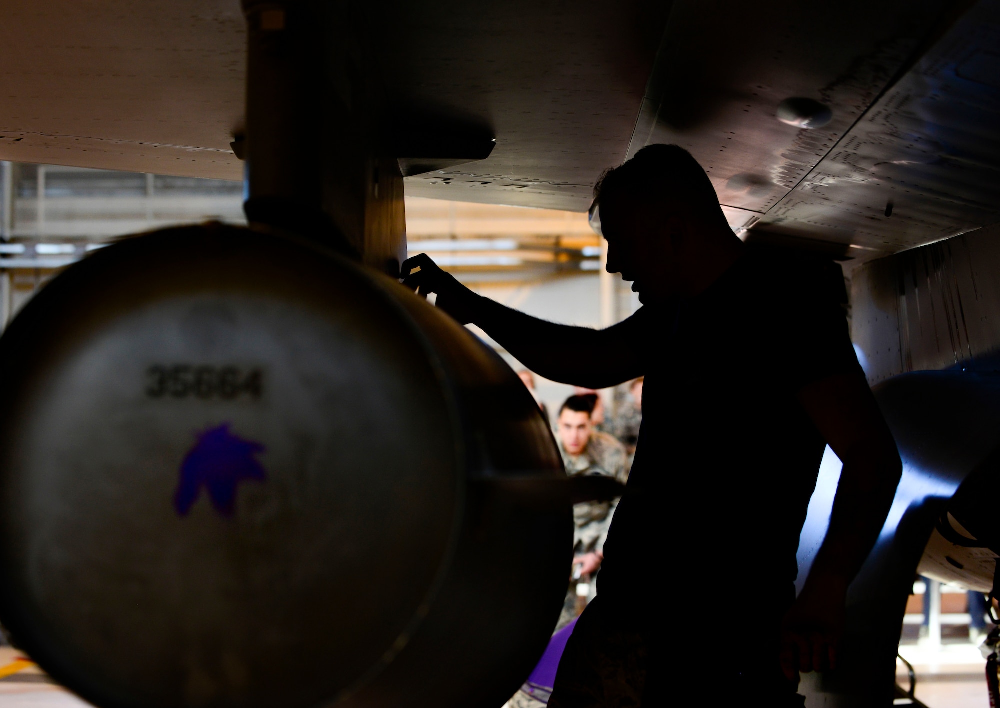 Senior Airman Donavhan Warrington, 31st Aircraft Maintenance Squadron weapons load crew member, inspects an F-16 Fighting Falcon during the annual load crew competition at Aviano Air Base, Italy on Jan. 6, 2016. The three 3-person teams were judged on their job knowledge, dress and appearance, and munitions load performance. (U.S. Air Force photo by Staff Sgt. Krystal Ardrey)