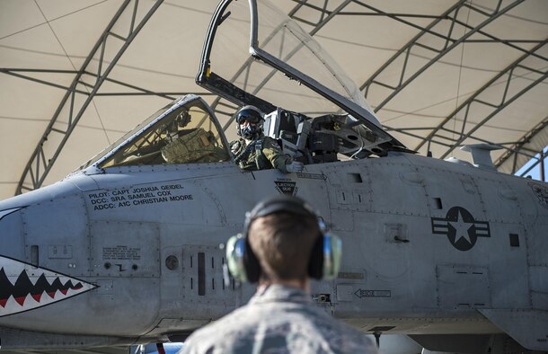 Capt. Thomas Ainscough, 74th Fighter Squadron A-10C Thunderbolt II pilot, talks with Senior Airman John Johnson, 23d Aircraft Maintenance Squadron crew chief, while waiting to taxi to the runway, Jan. 12, 2017, at Moody Air Force Base, Ga. All four military branches participate in two Green Flag exercises annually. (U.S. Photo by Airman 1st Class Janiqua P. Robinson)
