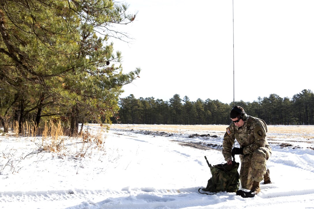 New Jersey Army National Guard Staff Sgt. Michael Bent communicates with Marine Corps aircraft during a joint-training exercise at Joint Base McGuire-Dix-Lakehurst, N.J., Jan. 10, 2017. Bent is a pathfinder assigned to the New Jersey Army National Guard’s 1st Battalion, 114th Infantry Regiment, 50th Infantry Brigade Combat Team. The Marines and aircraft are assigned to Marine Aircraft Group 49. Air National Guard photo by Tech. Sgt. Matt Hecht