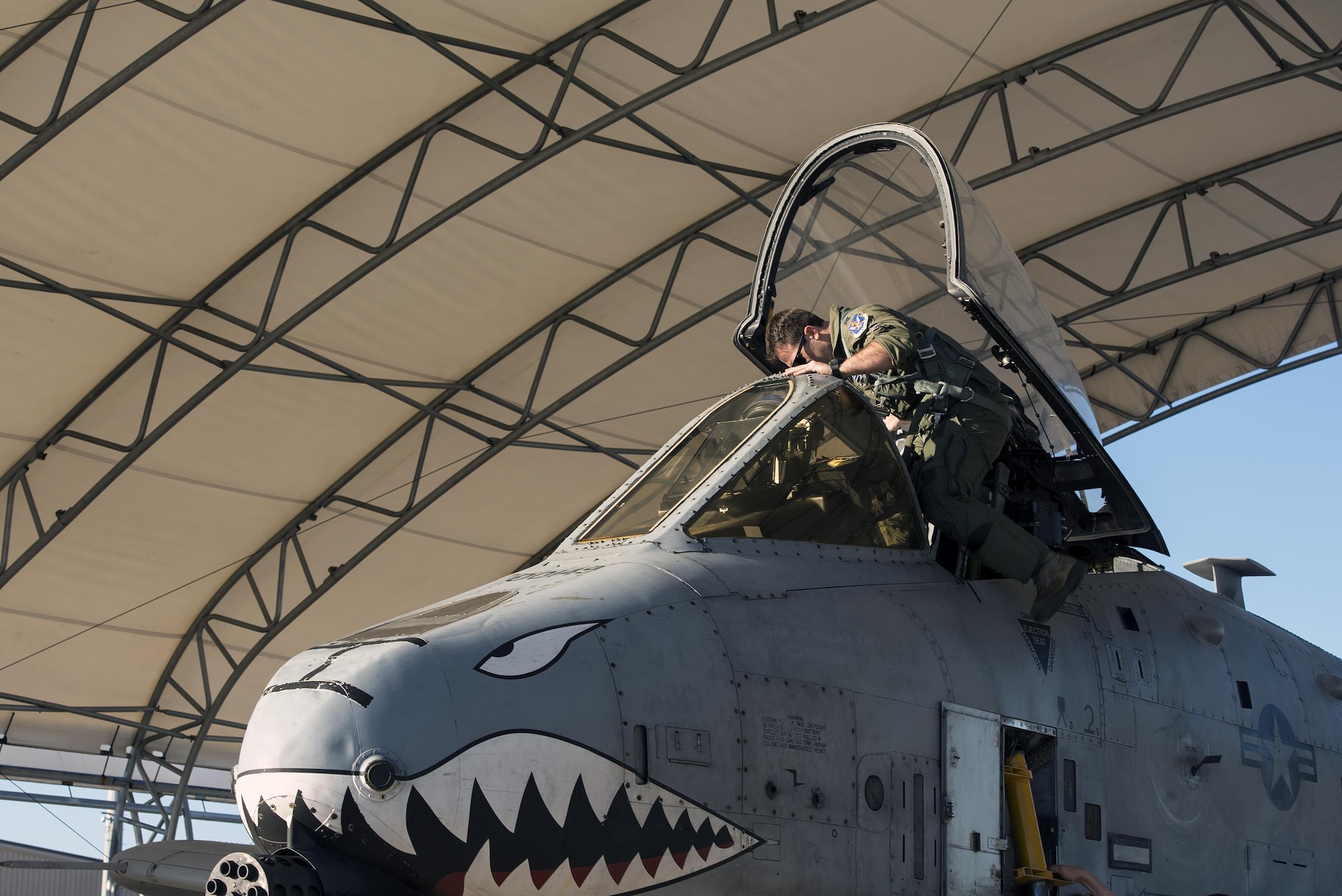 Capt. Andrew Nemethy, 74th Fighter Squadron A-10C Thunderbolt II pilot, climbs into the cockpit of an A-10 prior to launching for Green Flag-West, Jan. 12, 2017, at Moody Air Force Base, Ga. All four military branches, including the guard and reserve components, participate in two Green Flag exercises annually. Green Flag exercises provide joint training for approximately 75,000 joint and coalition personnel each year. (U.S. Air Force photo by Airman 1st Class Greg Nash)