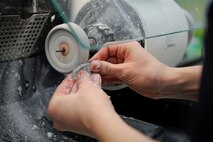 Staff Sgt. Maddie Gollnick, 86th Dental Squadron dental lab technician, pumices and polishes a hard night guard at Ramstein Air Base, Germany, Jan. 11, 2017. The 86th DS area dental laboratory ensures quality prosthodontics are made to prevent mishaps, restore, develop, and deploy Airmen from all over Europe. (U.S. Air Force photo by Airman 1st Class Savannah L. Waters)