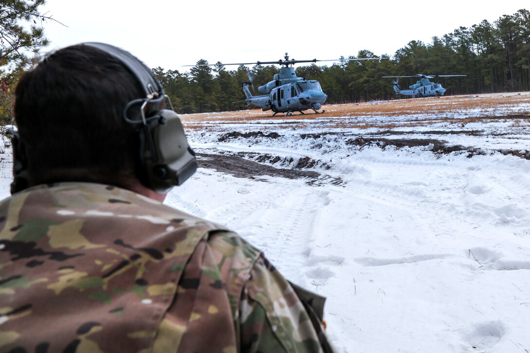 New Jersey Army National Guard Staff Sgt. Michael Bent communicates with Marine Corps aircraft during a joint-training exercise at Joint Base McGuire-Dix-Lakehurst, N.J., Jan. 10, 2017. Bent is a pathfinder assigned to the New Jersey Army National Guard’s 1st Battalion, 114th Infantry Regiment, 50th Infantry Brigade Combat Team. Air National Guard photo by Tech. Sgt. Matt Hecht
