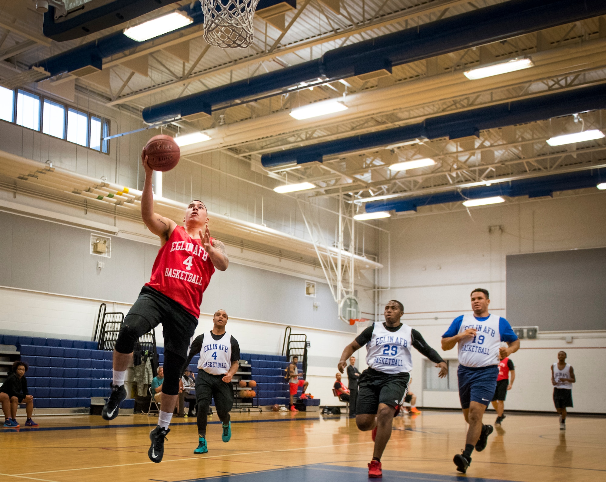 A Medical Group Black player drives to the basket for a lay-up during an intramural basketball game against the Maintenance Squadron team at Eglin Air Force Base, Fla., Jan. 12.  The MDG team won easily 30 to 25 in their first game of the new intramural season.  (U.S. Air Force photo/Samuel King Jr.)