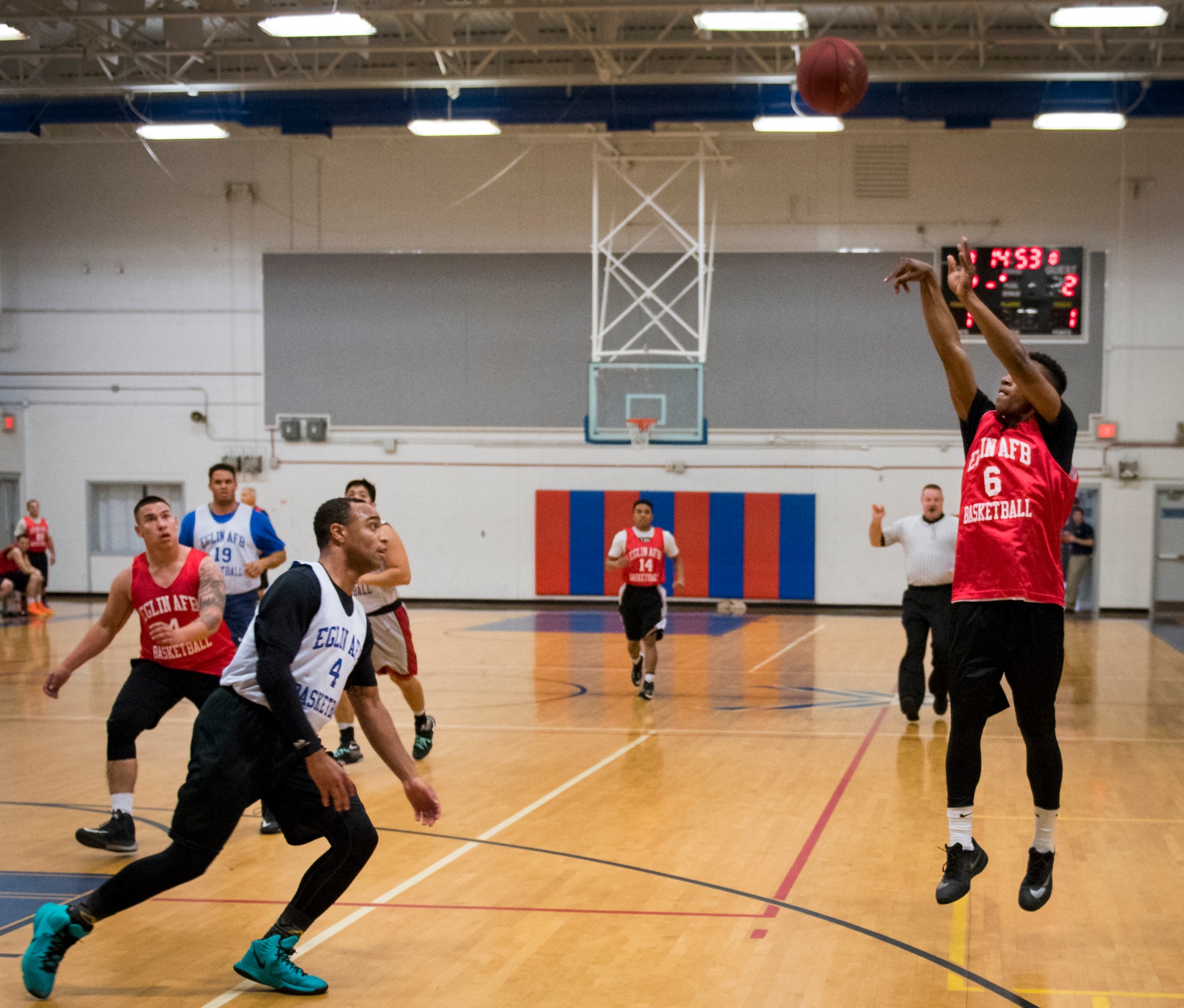 A Medical Group Black player shoots a three-pointer during an intramural basketball game against the Maintenance Squadron team at Eglin Air Force Base, Fla., Jan. 12.  The MDG team won easily 30 to 25 in their first game of the new intramural season.  (U.S. Air Force photo/Samuel King Jr.)