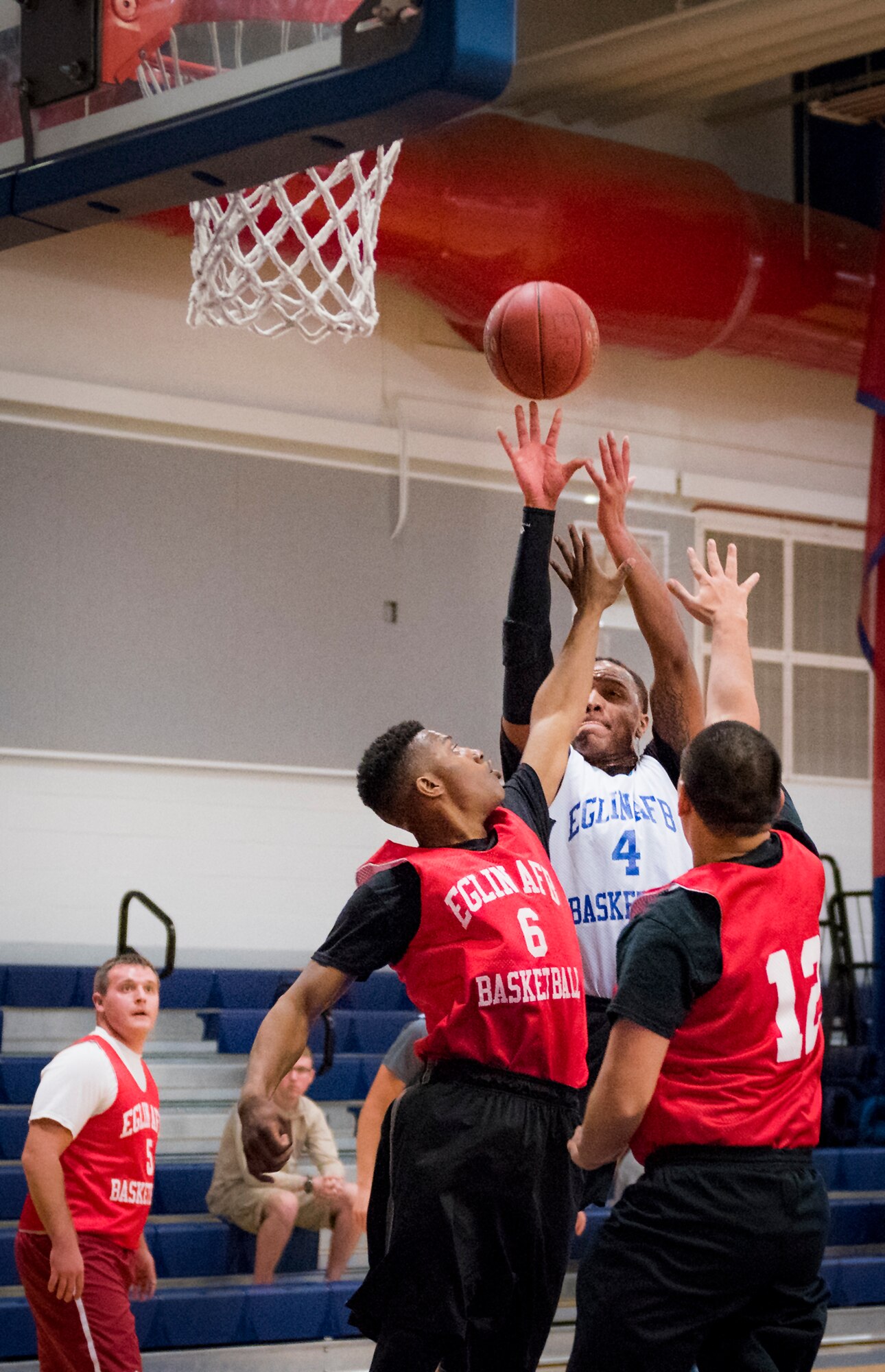 A Maintenance Squadron player shoots over two Medical Group Black defenders during their intramural basketball game at Eglin Air Force Base, Fla., Jan. 12.  The MDG team won easily 30 to 25 in their first game of the new intramural season.  (U.S. Air Force photo/Samuel King Jr.)
