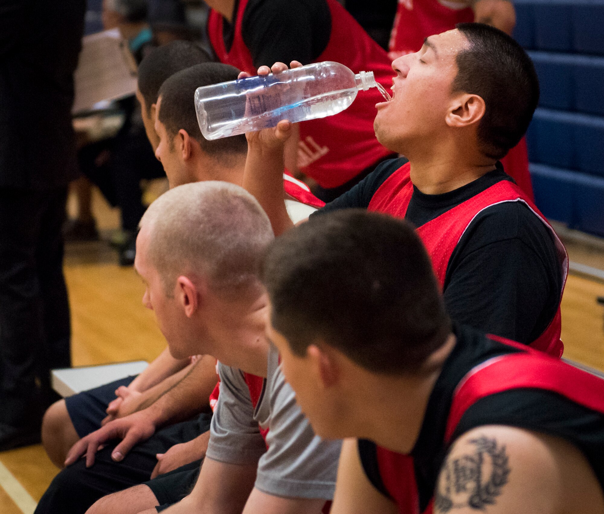 A Medical Group Black player takes a quick water break on the bench during an intramural basketball game against the Maintenance Squadron team at Eglin Air Force Base, Fla., Jan. 12.  The MDG team won easily 30 to 25 in their first game of the new intramural season.  (U.S. Air Force photo/Samuel King Jr.)