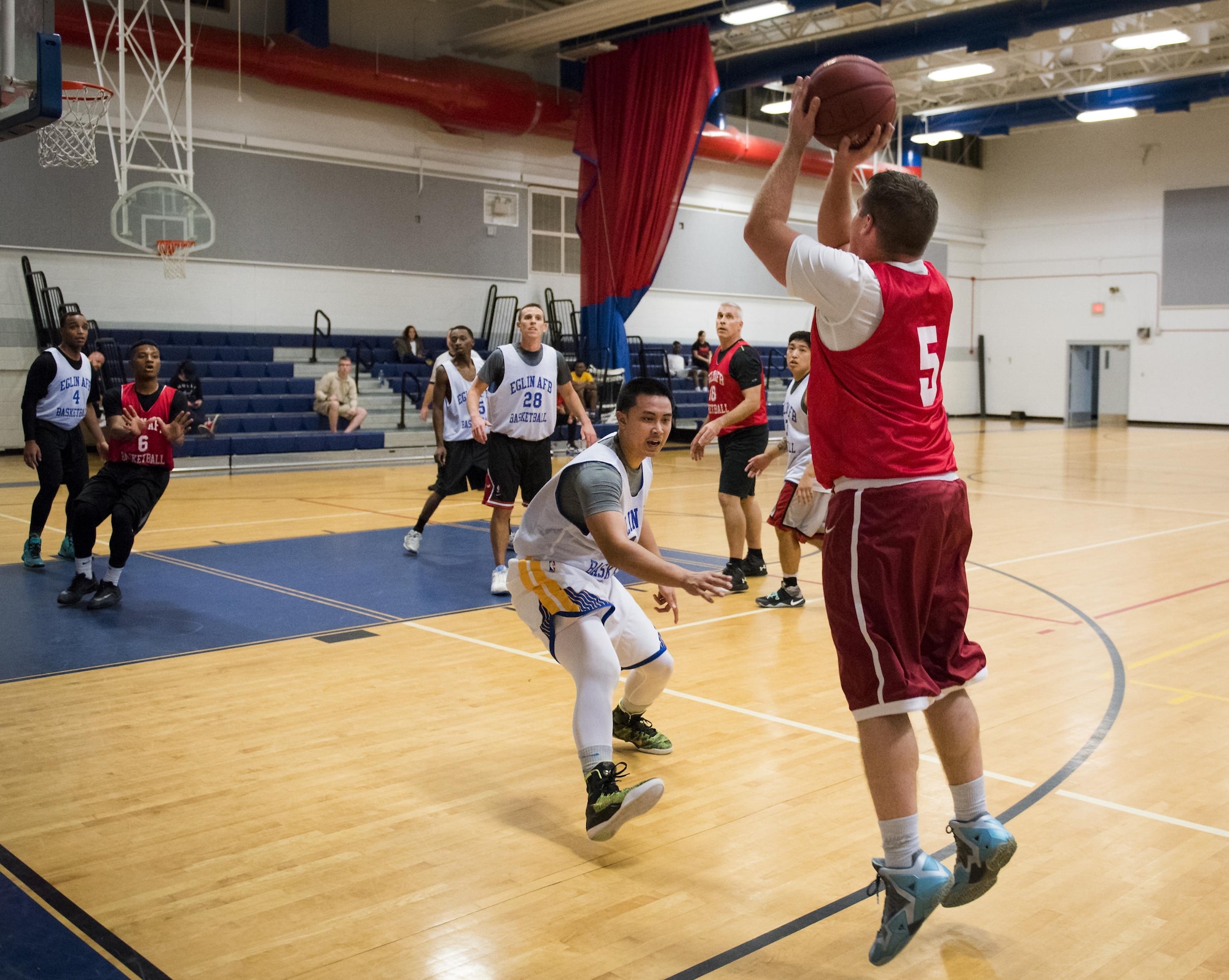 A Medical Group Black player shoots a three-pointer late into their intramural basketball game against the Maintenance Squadron team at Eglin Air Force Base, Fla., Jan. 12.  The MDG team won easily 30 to 25 in their first game of the new intramural season.  (U.S. Air Force photo/Samuel King Jr.)