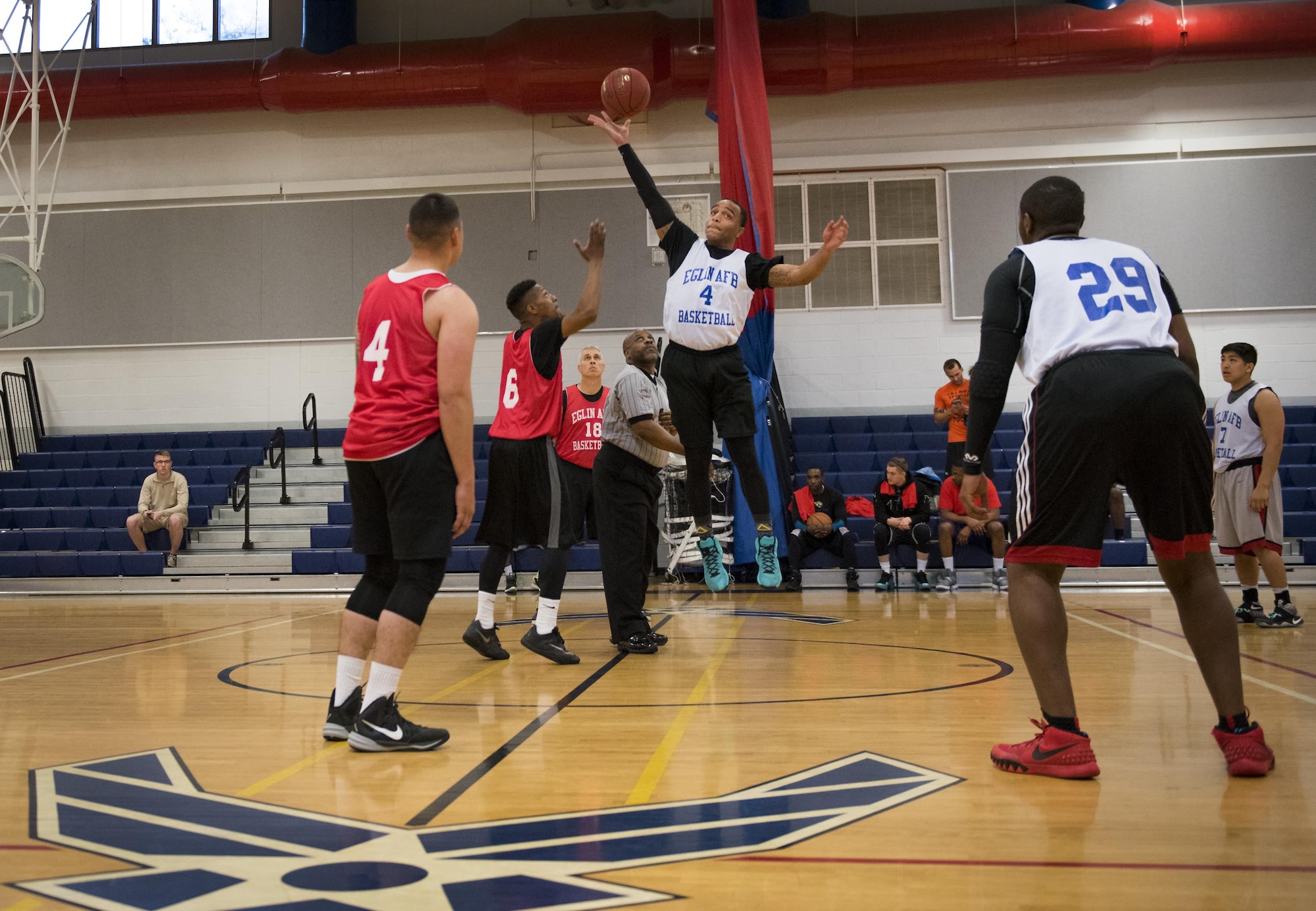 A Maintenance Squadron player grabs the tip off to begin an intramural basketball game against Medical Group Black at Eglin Air Force Base, Fla., Jan. 12.  The MDG team won easily 30 to 25 in their first game of the new intramural season.  (U.S. Air Force photo/Samuel King Jr.)