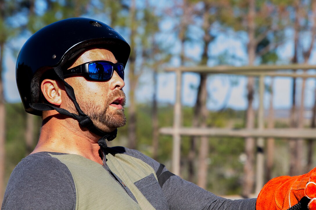 Alan Parmenter, a teacher from Mitchell High School, beings to descend down the rappel tower with the assistance of one of the instructors aboard Marine Corps Recruit Depot Parris Island, January 12, 2017. The rappel tower is one of the many events that recruits must pass to graduate boot camp, and is one of the events that make of the Educators Workshop. The Educators Workshop provides the opportunity for educators to have an inside look at Marine Corps training to better inform their students in their local area. (Photo by Cpl. John-Paul Imbody/Released)