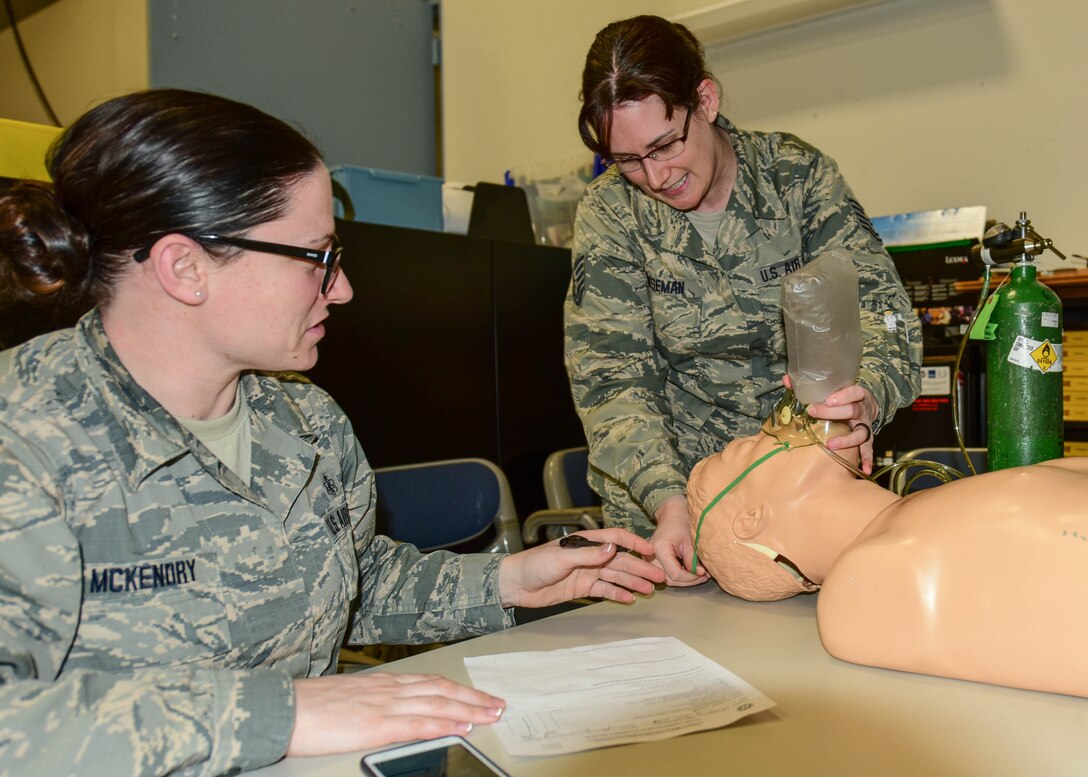 Staff Sgt. Jennifer A. McKendry, EMT instructor coordinator and Medical Technician with the 914th Aeromedical Staging Squadron, oversees Tech. Sgt. Megan L. Houseman, Medical Technician, 914 ASTS, as she demonstrates proper oxygen administration to a mannequin at the Niagara Falls Air Reserve Station, N.Y., January 12, 2016. Houseman was one of 26 military students who took part in a biannual training to recertify for the National Registry for Emergency Medical Technicians. The joint training involved members of the 914 ASTS, 914th Aeromedical Evacuation Squadron, 914th Fire Emergency Services, and the 107th Attack Wing. (U.S. Air Force photo by Peter Borys)