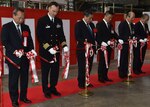 Capt. Matthew Edwards, commander, Fleet Readiness Center Western Pacific, joins Japanese city officials, business executives, and Japanese Ground Self-Defense Force (JGSDF) leaders in a ribbon cutting ceremony for the newly opened MV-22 Osprey, depot-level repair facility in JGSDF airfield, Camp. Kisarazu, Jan. 12, 2017. The facility is the first depot level facility for the MV-22 to open in Japan and will serve a critical role in keeping forward-deployed aircraft operational. 
