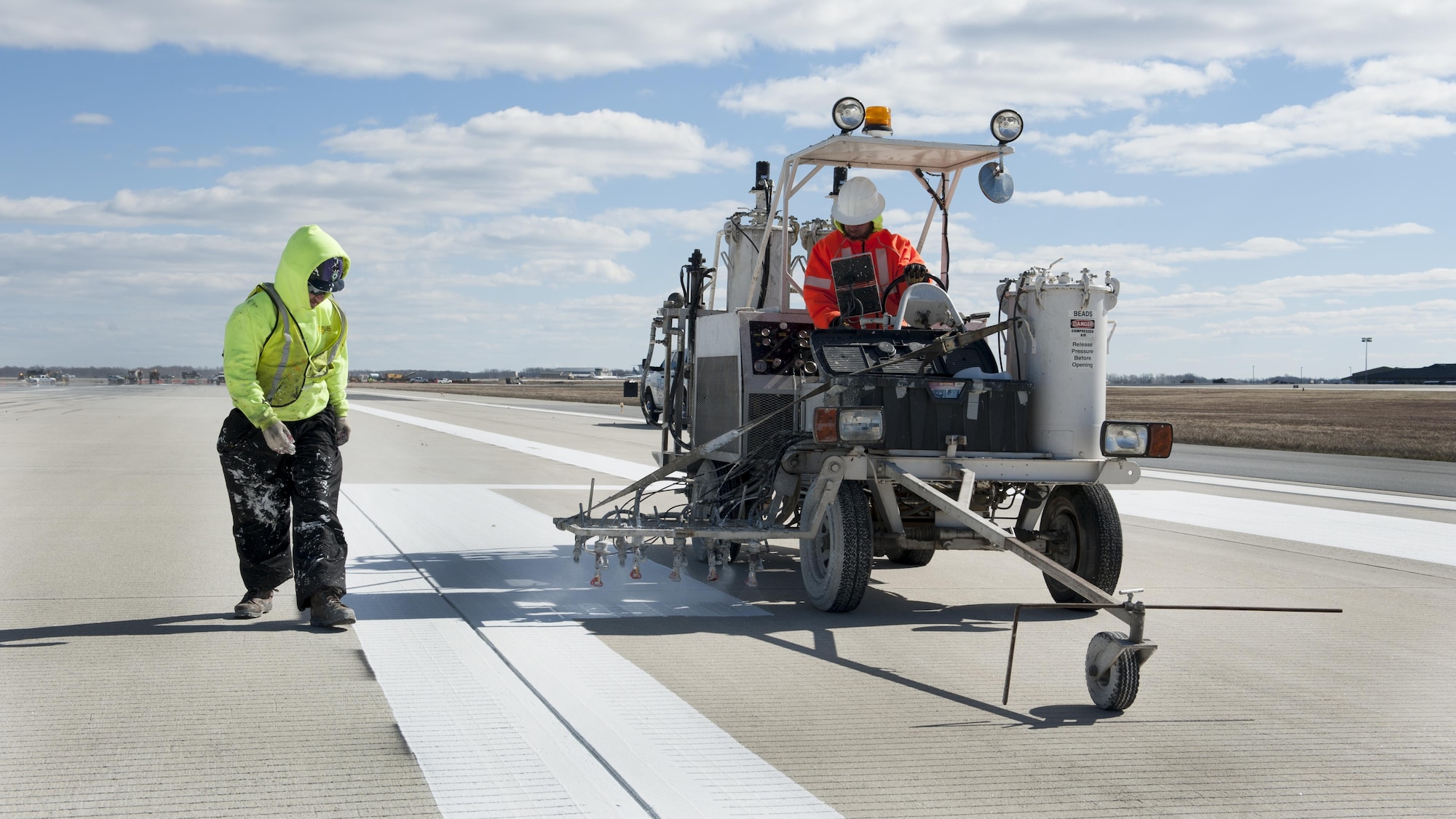 A crew repaints a runway Feb. 26, 2016, at Dover Air Force Base, Del. The Installation Health Assessment is a framework that helps the Air Force manage installation and mission support functions so it can put the next dollar against the most important requirement. (U.S. Air Force photo/Senior Airman Zachary Cacicia)