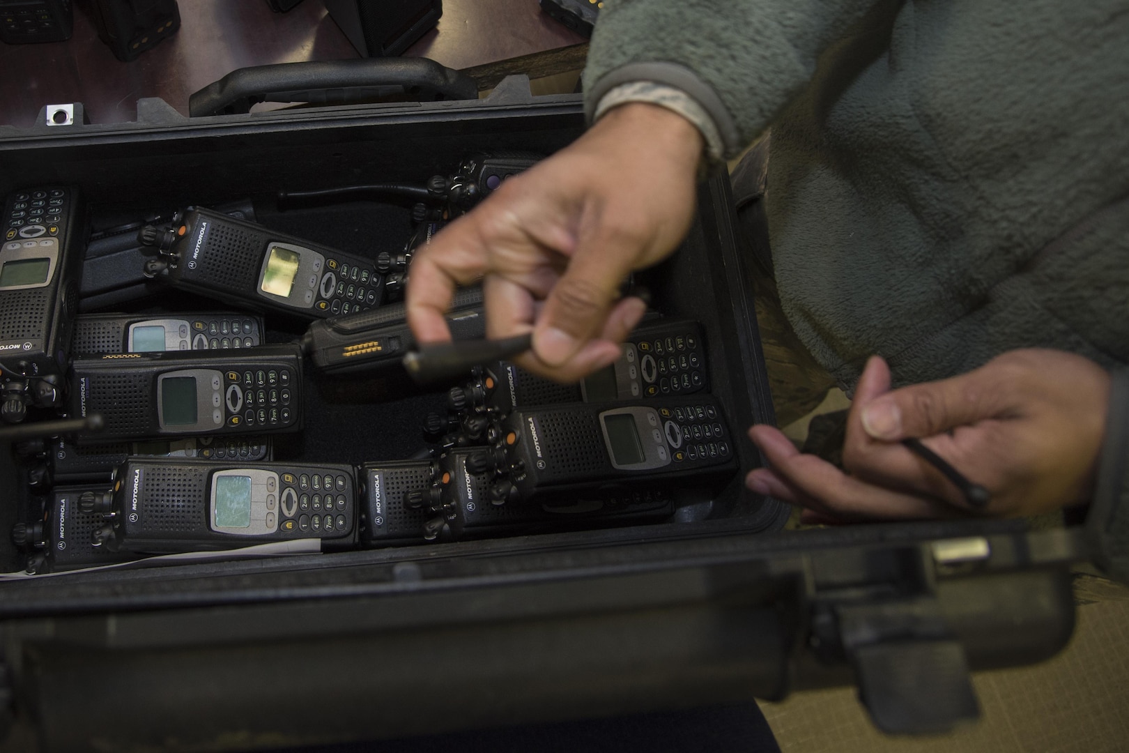 A 744th Communications Squadron radio frequency transmission system technician prepares land mobile radios for pick up on Joint Base Andrews, Md., Jan. 11, 2017. The 744th CS plays an important role in ensuring communication is running smoothly. Airmen participating in the 58th Presidential Inauguration will be using approximately 200 LMRs provided by the 744th CS.  (U.S. Air Force photo by Airman 1st Class Valentina Lopez)