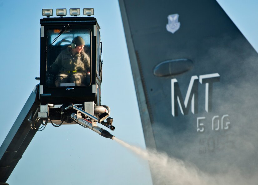 Airman 1st Class Samantha Coleman, 5th Aircraft Maintenance electronic countermeasures specialist, de-ices a B-52H Stratofortress at Minot Air Force Base, N.D., Jan. 11, 2017. A mixture of heated fluid and hot water is sprayed on the bombers prior to launching in cold weather conditions. 5th AMXS Airmen work in all weather conditions to provide B-52 global strike capabilities. (U.S. Air Force photo/Airman 1st Class J.T. Armstrong)