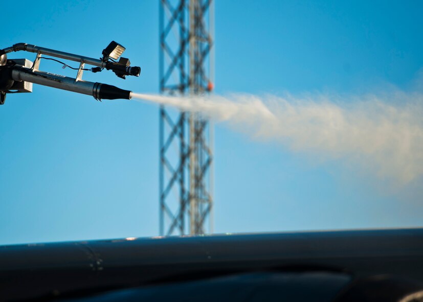 Airman 1st Class Samantha Coleman, 5th Aircraft Maintenance electronic countermeasures specialist, de-ices a B-52H Stratofortress at Minot Air Force Base, N.D., Jan. 11, 2017. A mixture of heated fluid and hot water is sprayed on the bombers prior to launching in cold weather conditions. 5th AMXS Airmen work in all weather conditions to provide B-52 global strike capabilities. (U.S. Air Force photo/Airman 1st Class J.T. Armstrong)