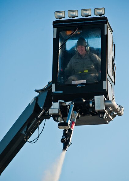 Airman 1st Class Samantha Coleman, 5th Aircraft Maintenance electronic countermeasures specialist, de-ices a B-52H Stratofortress at Minot Air Force Base, N.D., Jan. 11, 2017. A mixture of heated fluid and hot water is sprayed on the bombers prior to launching in cold weather conditions. 5th AMXS Airmen work in all weather conditions to provide B-52 global strike capabilities. (U.S. Air Force photo/Airman 1st Class J.T. Armstrong)