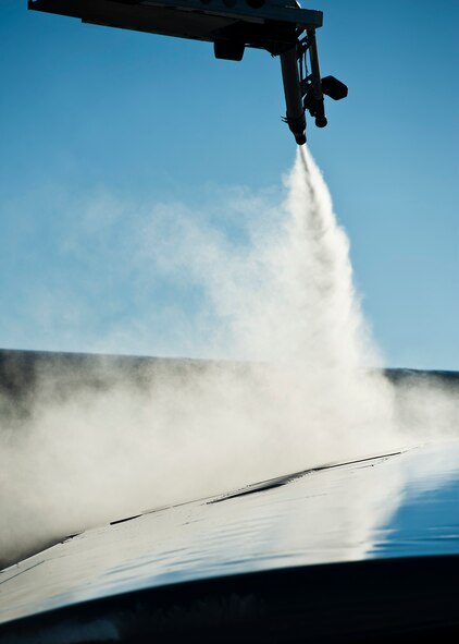 Airman 1st Class Samantha Coleman, 5th Aircraft Maintenance electronic countermeasures specialist, de-ices a B-52H Stratofortress at Minot Air Force Base, N.D., Jan. 11, 2017. A mixture of heated fluid and hot water is sprayed on the bombers prior to launching in cold weather conditions. 5th AMXS Airmen work in all weather conditions to provide B-52 global strike capabilities. (U.S. Air Force photo/Airman 1st Class J.T. Armstrong)