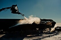 Airman 1st Class Samantha Coleman, 5th Aircraft Maintenance electronic countermeasures specialist, de-ices a B-52H Stratofortress at Minot Air Force Base, N.D., Jan. 11, 2017. A mixture of heated fluid and hot water is sprayed on the bombers prior to launching in cold weather conditions. 5th AMXS Airmen work in all weather conditions to provide B-52 global strike capabilities. (U.S. Air Force photo/Airman 1st Class J.T. Armstrong)