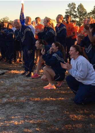 Airmen cheer for their respective wings during a tug-of-war competition during the Wingman Day Olympics here, Jan. 13. For Wingman Day Airmen participated in various events with their squadrons to foster teamwork and communication while covering the four domains of Comprehensive Airmen Fitness.