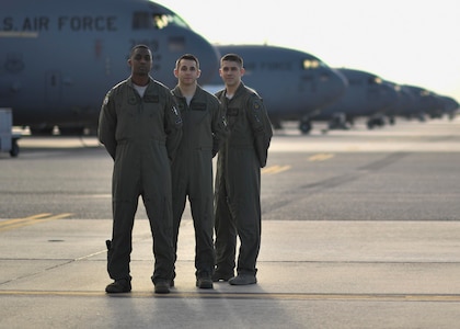 Capt. James Hall, 14th Airlift Squadron (AS) tactics flight commander, left, Capt. Matt Eggert, 16th AS pilot, center, Capt. Jeff Harnly, 16th Airlift Squadron evaluator, right, stand on the flightline here, Jan. 12, 2017. Hall, Eggert and Harnly recently graduated from the U.S. Air Force Weapons School where they learned to be tactical experts in C-17 Globemaster IIIs as well as experts in integration across all platforms in the Air Force. 
