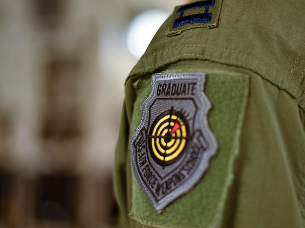 Capt. Jeff Harnly, 16th Airlift Squadron evaluator, wears the U.S. Air Force Weapons School graduate patch here, Jan. 12, 2016. Harnly and two other pilots recently graduated from the U.S. Air Force Weapons School where they learned to be tactical experts in C-17 Globemaster IIIs as well as experts in integration across all platforms in the Air Force.
