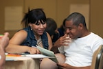 Spc. Jerronn Lee, right, with the District of Columbia Army National Guard’s 547th Transportation Company, and his wife Charlotte Lee, work together on a relationship-building exercise during a 2014 Strong Bonds event in Alexandria, Virginia. Strong Bonds, a chaplain-led program, helps Guard members strengthen relationship and individual resiliency by teaching effective communication skills with each other. 