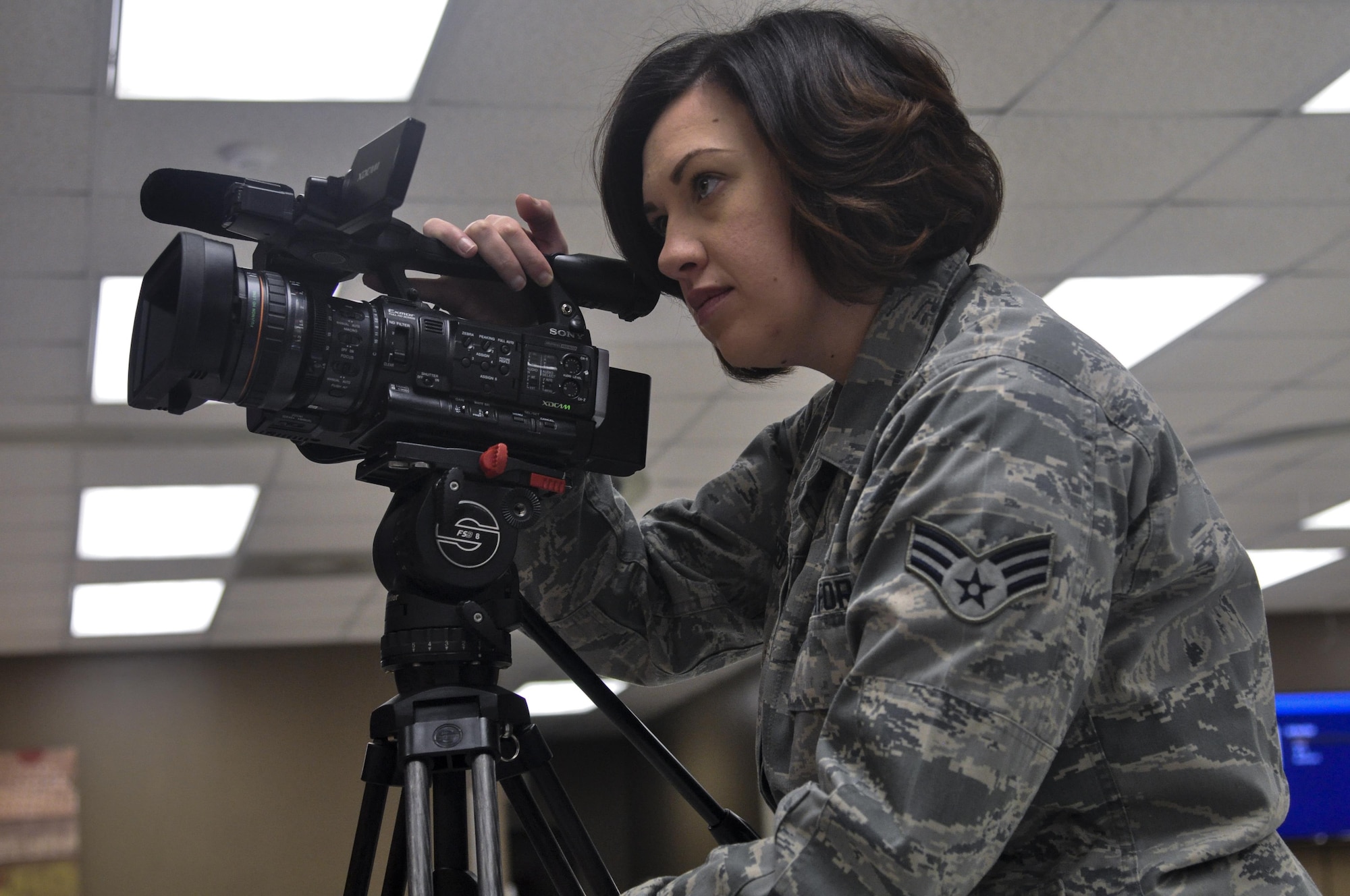 U.S. Air Force Senior Airman Megan Reed, 17th Training Wing Public Affairs broadcast journalist, gathers b-roll of the grand opening of a coffee shop on Goodfellow Air Force Base, Texas, January 13, 2016. The Public Affairs office covers events happening on or off base that impact Godfellow. (U.S. Air Force photo by 2nd Lt. Tisha Wilkerson/Released)