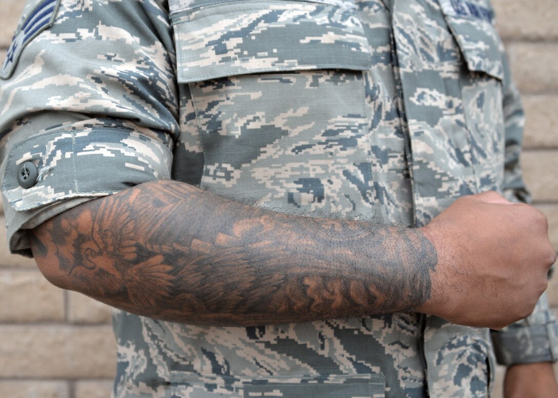 The Air Force announced new policies on dress and appearance with regard to tattoos, Jan. 9, 2017. Authorized tattoos on the chest, back, arms and legs will no longer be restricted by the “25 percent” rule, while tattoos, brands or body markings on the head, neck, face, tongue, lips and/or scalp remain prohibited. (U.S. Air Force photo by Senior Airman Devante Williams)