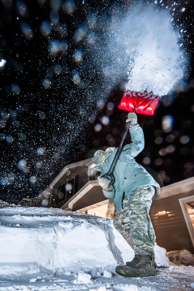 Airman 1st Class J.T. Armstrong, 5th Bomb Wing photojournalist, shovels snow at Minot Air Force Base, N.D., Jan. 12, 2017. When going outside for even a short period of time, it’s important to remember that if not properly prepared, North Dakota’s cold temperatures and wind chills can be dangerous. (U.S. Air Force photo/Airman 1st Class J.T. Armstrong)