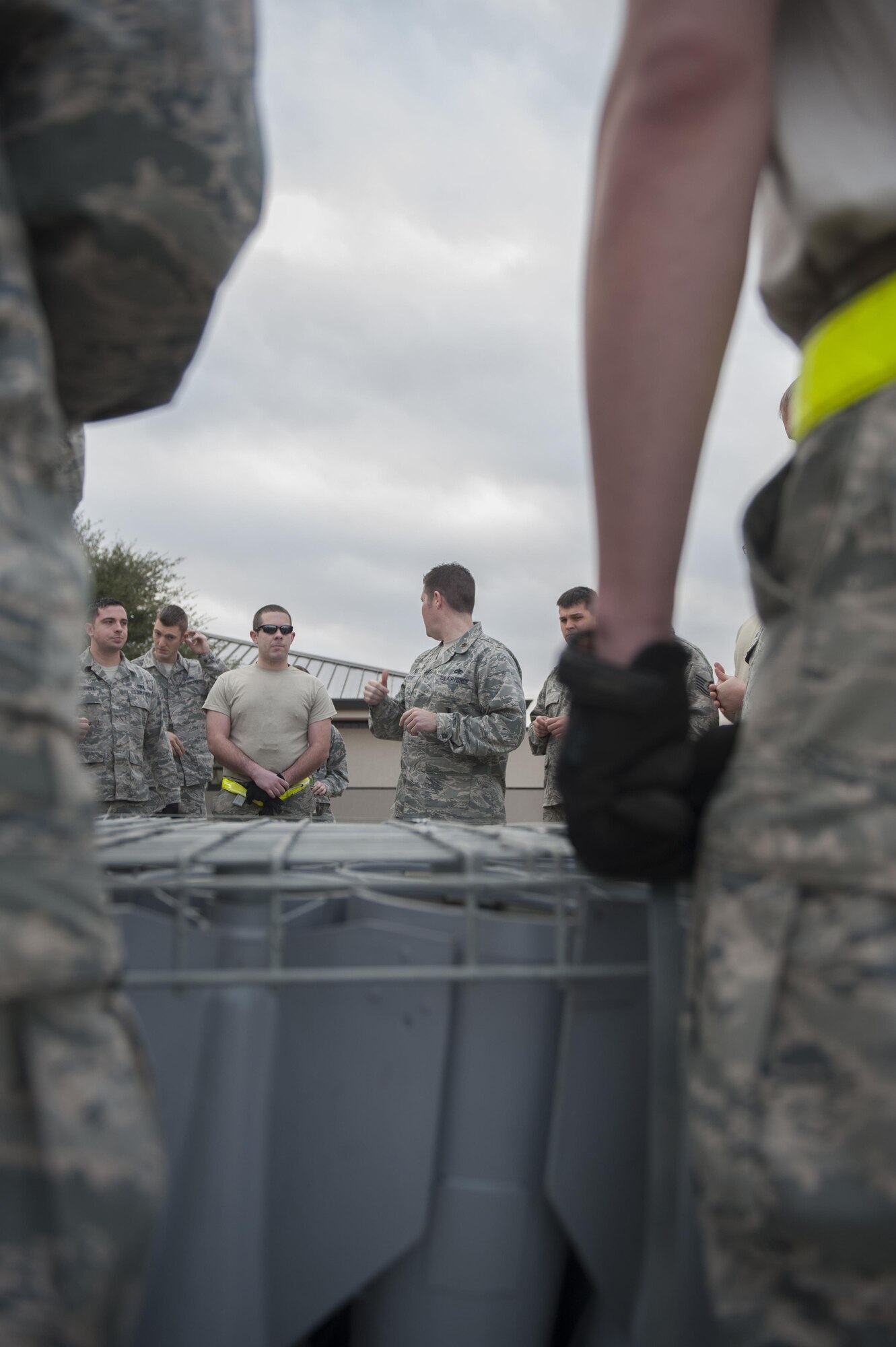 U.S. Air Force Maj. Jeremy McCraney, 7th Munitions Squadron commander, opens the 7th MUNS quarterly bomb build competition by speaking to Airmen on the two competing teams at Dyess Air Force Base, Texas, Jan. 12, 2017. The competition included two separate teams of nine Airmen each, gold and green, who work from various shops within the 7th MUNS. (U.S. Air Force photo by Airman 1st Class Rebecca Van Syoc)