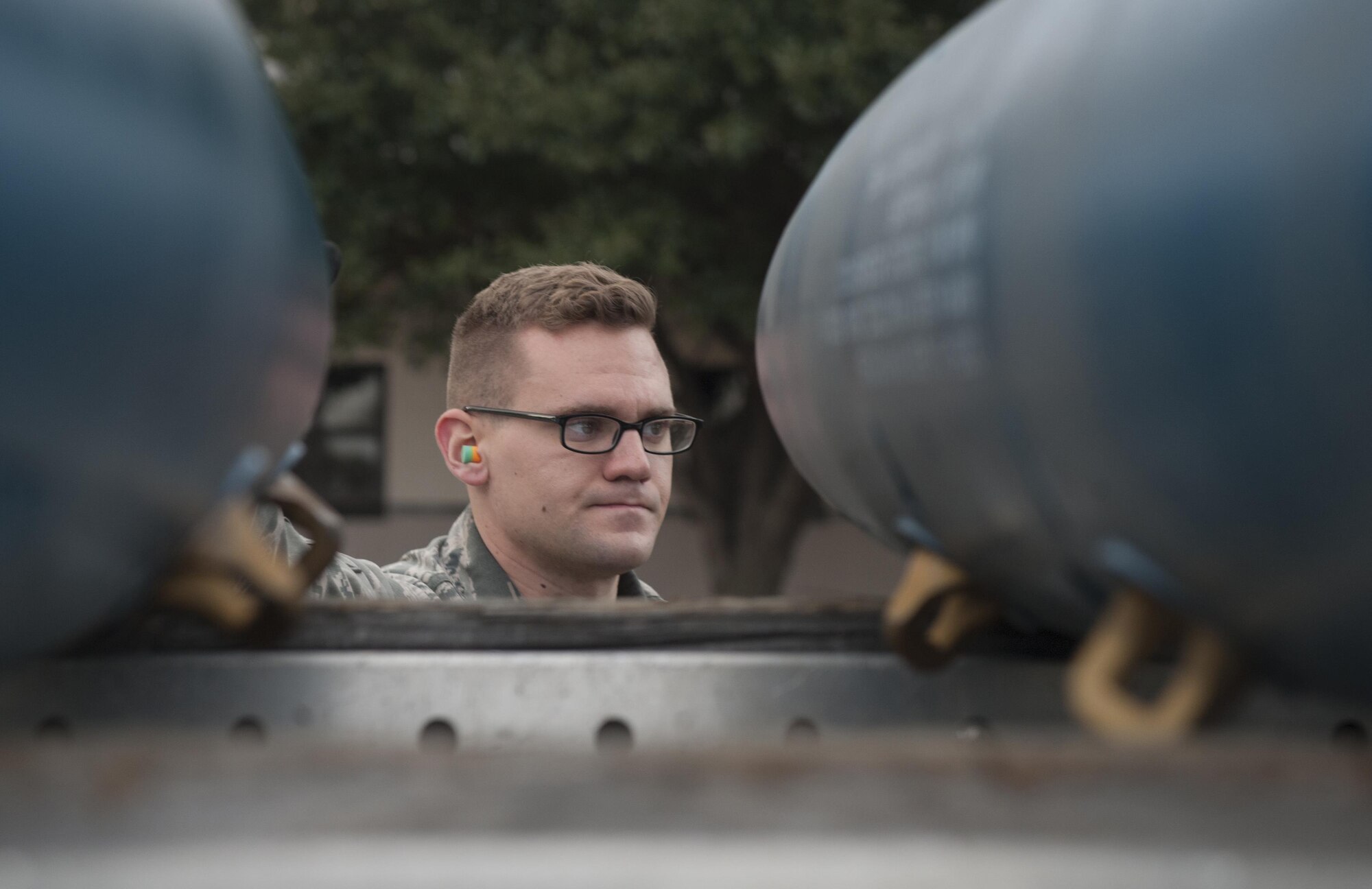 U.S. Air Force Senior Airman Andrew Mote, 7th Munitions Squadron gold team member, looks over several BDU-50 low-drag munitions during the 7th MUNS quarterly bomb build competition at Dyess Air Force Base, Texas, Jan. 12, 2017. This was the fifth quarterly bomb build competition that has helped more than 100 competitors improve technical skills and proficiency. (U.S. Air Force photo by Airman 1st Class Rebecca Van Syoc)