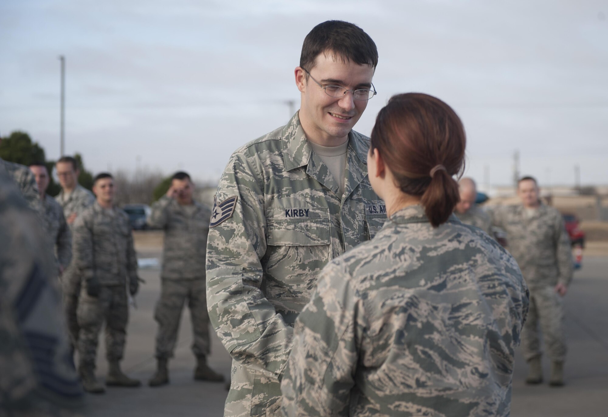 U.S. Air Force Staff Sgt. Chris Kirby, left, 7th Munitions Squadron green team member, accepts a certificate from Capt. Emily Barielle, right, 7th MUNS operation officer, at Dyess Air Force Base, Texas, Jan. 12, 2017. The green team won the 7th MUNS quarterly bomb build competition earning the winning Airmen a certificate, one-day pass, and bragging rights until the next quarterly competition. (U.S. Air Force photo by Airman 1st Class Rebecca Van Syoc)