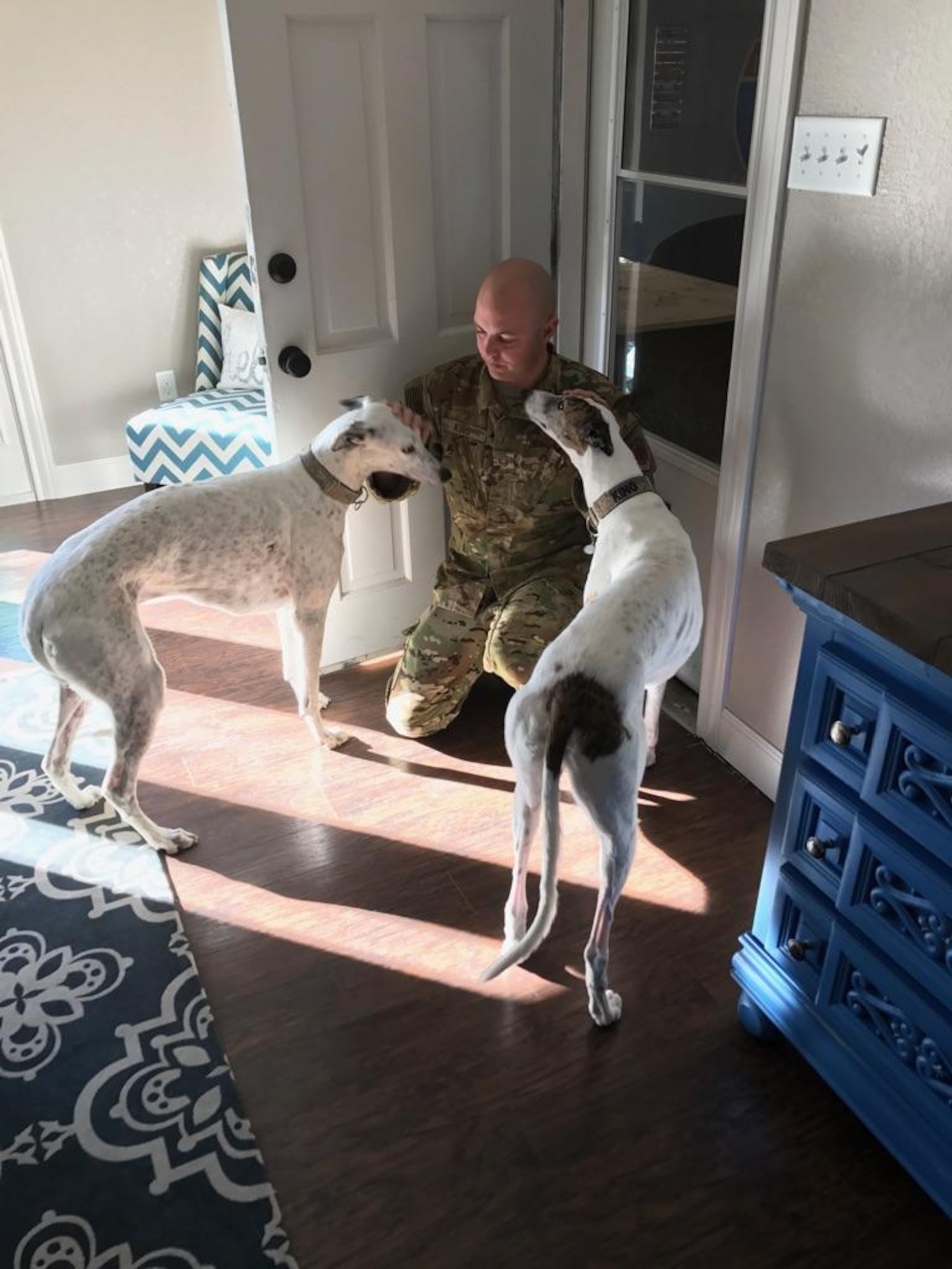 U.S. Air Force Staff Sgt. Justin King, 39th Airlift Squadron loadmaster, says goodbye to his two dogs, Avalanche and Handsome, Jan. 6, 2017. King, along with his unit, departed that day on a rotational deployment to Afghanistan. (Courtesy photo by Amanda King)