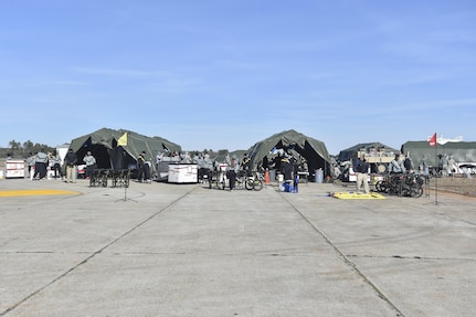 Soldiers from the 414th Chemical, Biological, Radiological and Nuclear Company and the 409th Area Support Medical Company setup temporary treatment facilities, consisting of five tents, during a mass casualty and decontamination exercise at North Auxiliary Airfield in North, South Carolina Jan. 10, 2017. Both units work hand-in-hand to setup a treatment center capable of decontaminating and caring for victims of a CBRN attack within two and a half hours of arriving on scene. North Auxiliary Airfield is a Joint Base Charleston asset capable of hosting a wide range of exercises.