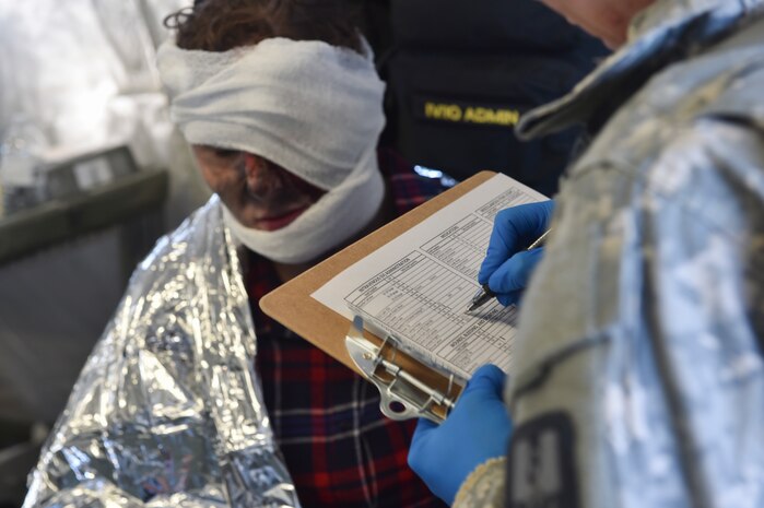 U.S. Army 2nd Lt. Amie Billstrom, 409th Area Support Medical Company physician assistant, treats a simulated patient during a mass casualty and decontamination exercise at North Auxiliary Airfield in North, South Carolina Jan. 10, 2017. The temporary treatment facilities allow for the 414th Chemical, Biological, Radiological and Nuclear Company and 409th ASMC to work together to triage patients, decontaminate them and provide medical care quickly. North Auxiliary Airfield is a Joint Base Charleston asset capable of hosting a wide range of exercises.