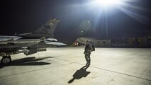 Capt. David, 79th Expeditionary Fighter Squadron pilot, walks out to an F-16 Fighting Falcon before a night mission Jan. 13, 2017 at Bagram Airfield, Afghanistan. David enlisted in the Air Force in 2004 as an F-16 avionics specialist and now flies the same airframe he used to maintain. (U.S. Air Force photo by Staff Sgt. Katherine Spessa)