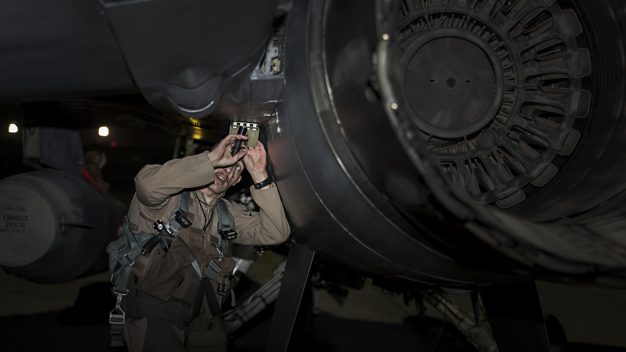 Capt. David, 79th Expeditionary Fighter Squadron pilot, performs a walk-around on an F-16 Fighting Falcon before a night mission Jan. 13, 2017 at Bagram Airfield, Afghanistan. David is at Bagram on his first deployment as a fighter pilot. (U.S. Air Force photo by Staff Sgt. Katherine Spessa)