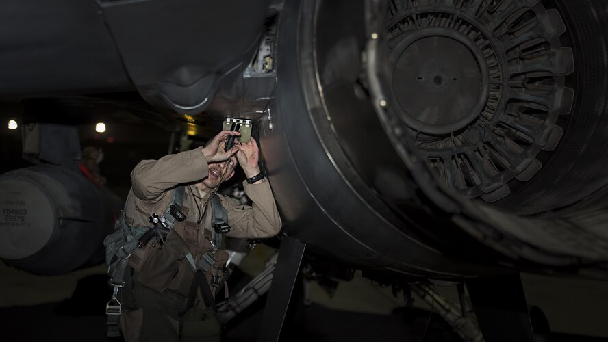 Capt. David, a 79th Expeditionary Fighter Squadron pilot, performs a prefight inspection on an F-16 Fighting Falcon before a night mission Jan. 13, 2017, at Bagram Airfield, Afghanistan. David is at Bagram Airfield on his first deployment as a fighter pilot. (U.S. Air Force photo/Staff Sgt. Katherine Spessa)