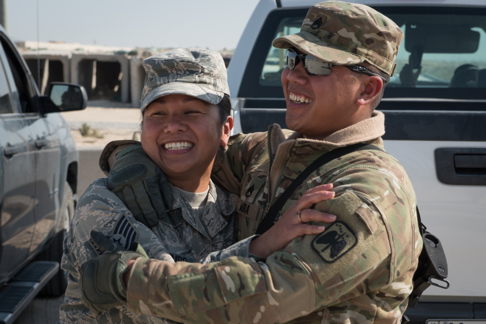 U.S. Air Force Tech. Sgt. Mary Jane Palumbo, 134th Expeditionary Fighter Squadron aviation resource manager, and her brother, U.S. Army Staff Sgt. Quincy Mora, AH-64 Apache mechanic, embrace one another as they meet for the first time in ten years Jan. 7, 2017. The siblings are both deployed in support of Operation Inherent Resolve. (U.S. Air Force photo/Master Sgt. Benjamin Wilson)(Released)