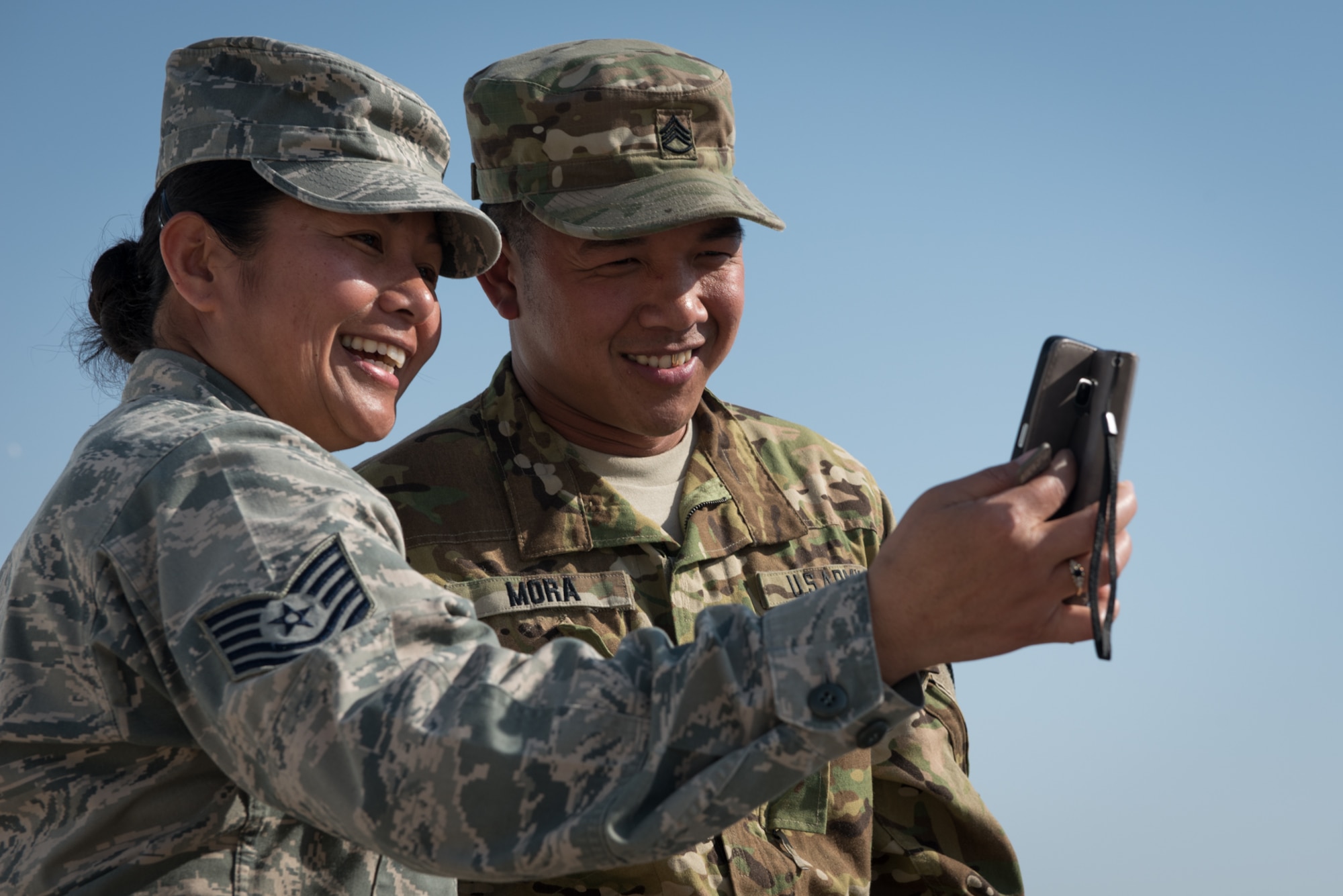 U.S. Air Force Tech. Sgt. Mary Jane Palumbo, 134th Expeditionary Fighter Squadron aviation resource manager, and her brother, U.S. Army Staff Sgt. Quincy Mora, AH-64 Apache mechanic, video chat with family, while deployed Jan. 7, 2017. The brother and sister are originally from the Federated States of Micronesia and have not seen one another in ten years. (U.S. Air Force photo/Master Sgt. Benjamin Wilson)(Released)