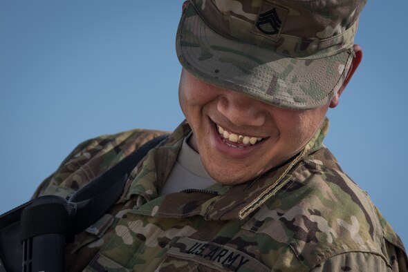U.S. Army Staff Sgt. Quincy Mora, AH-64 Apache mechanic, smiles as he speaks with his sister, U.S. Air Force Tech. Sgt. Mary Jane Palumbo, 134th Expeditionary Fighter Squadron aviation resource manager, Jan. 7, 2017. The two had a chance to see each other for the first time in ten years, as their paths crossed while deployed in support of Operation Inherent Resolve. (U.S. Air Force photo/Master Sgt. Benjamin Wilson)(Released)