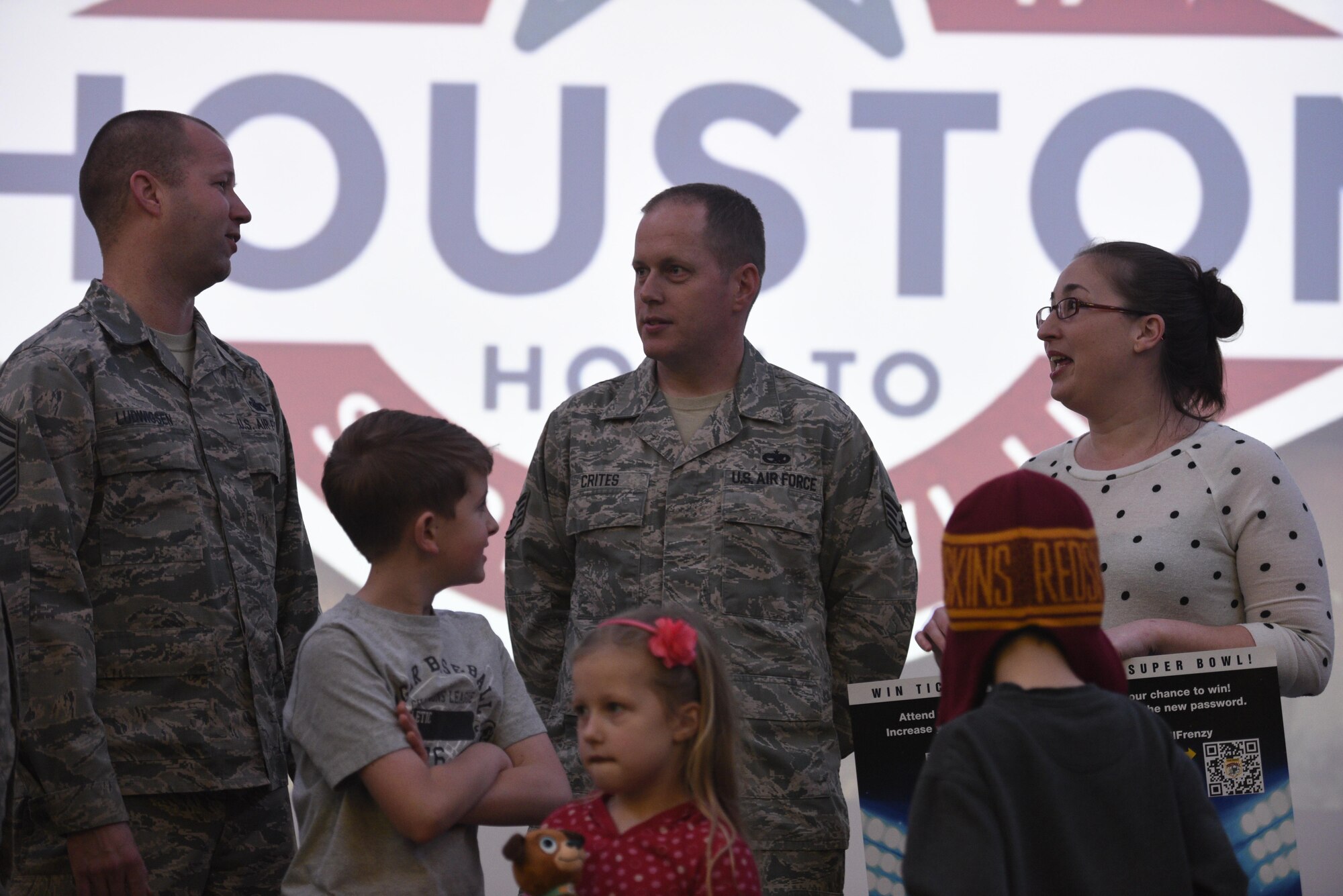 Stephanie Crites, right, wife of U.S. Air Force Staff Sgt. Richard Crites, middle, 52nd Maintenance Squadron senior munitions inspector, talks with Chief Master Sgt. Edwin Ludwigsen, 52nd Fighter Wing command chief, after being presented with the grand prize from the Football Frenzy contest at Club Eifel on Spangdahlem Air Base, Germany, Jan. 10, 2017. The grand prize is two tickets to Super Bowl LI with airfare and hotel. (U.S. Air Force photo by Staff Sgt. Jonathan Snyder)