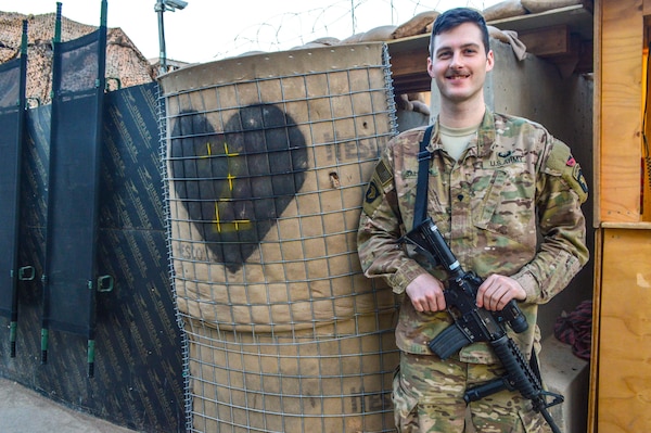 Spc. Erik Salmon, 26, an intelligence analyst assigned to the 2nd Brigade Combat Team, 101st Airborne Division, poses for a photograph while deployed in support of Operation Inherent Resolve, at Camp Swift, Jan. 8, 2017. Salmon assisted in the recovery of an isolated Iraqi Security Forces (ISF) soldier while working as a member of a U.S. and Iraqi advise and assist operations cell. U.S. Soldiers, alongside international coalition partners, are supporting the Government of Iraq and the ISF as they wage war against the terrorist group, the Islamic State of Iraq and the Levant (ISIL).  (U.S. Army photo by Maj. Ireka R. Sanders)