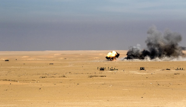 An M30A1 explodes on target vehicles configured into a convoy at Udairi Training Range in Kuwait, recently. The munitions are being used to replace “cluster bomb” munitions with tungsten steel pellets to target soft vehicles and enemy personnel without leaving potential unexploded ordinance on the battlefield. (U.S. Army photo by Sgt. Brandon Hubbard, USARCENT Public Affairs)