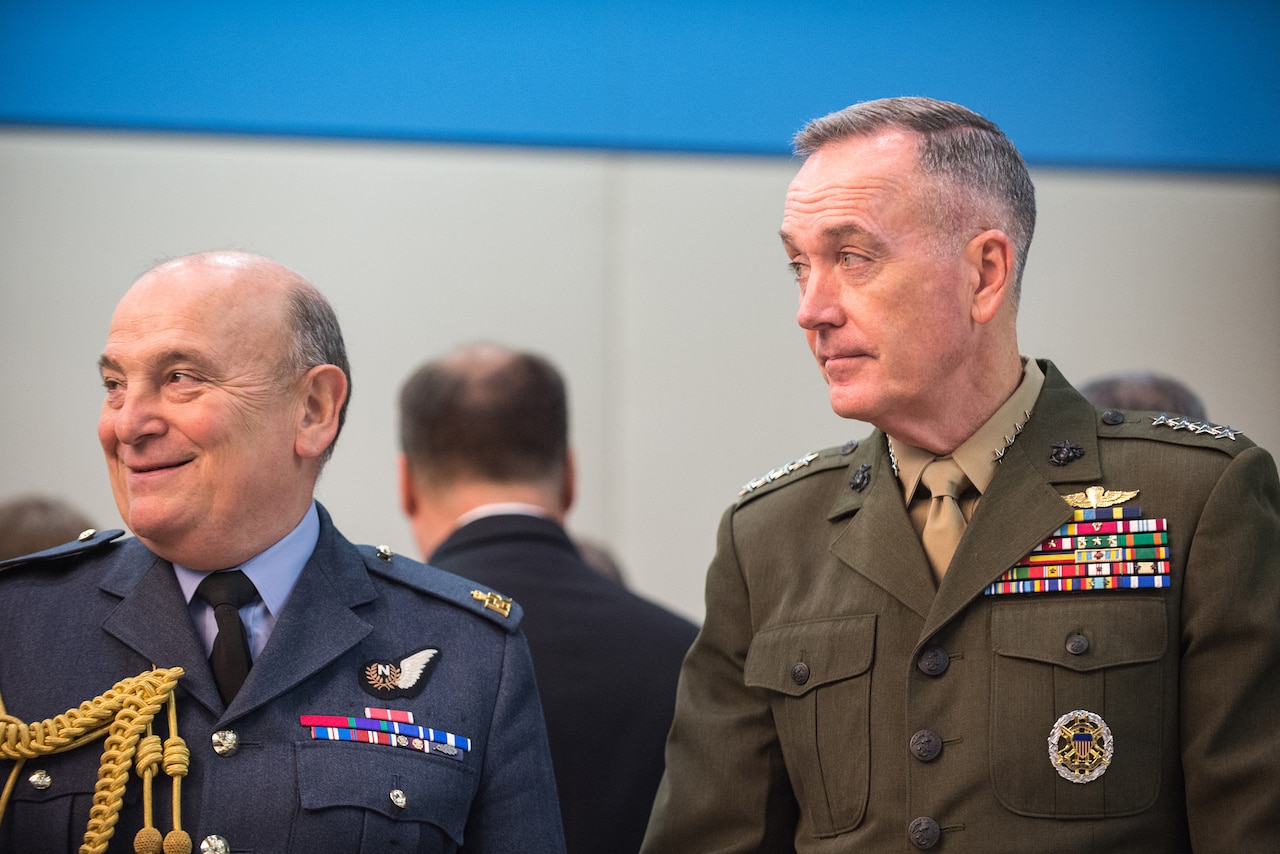 Marine Corps Gen. Joe Dunford, chairman of the Joint Chiefs of Staff, speaks with Air Chief Marshal Sir Stuart Peach, the United Kingdom’s chief of defense, before a meeting of the NATO Military Committee alliance at the alliance’s headquarters in Brussels, Jan. 17, 2017. DoD photo by Army Sgt. James K. McCann