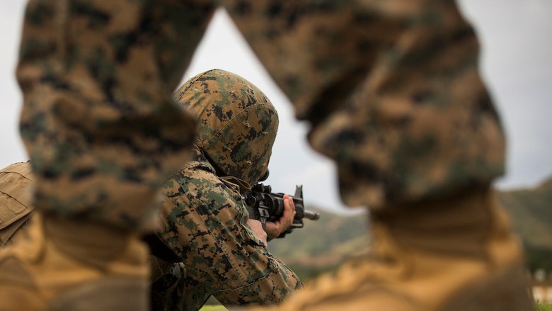 Lance Cpl. Robert M. Martinez Jr., sends rounds down range during table two of his annual rifle range qualification, Jan. 12, 2017, at Camp Hansen, Okinawa, Japan. The Marine Corps revised table two of the marksmanship program to increase marksmanship skill and realism in a combat environment. The Corps requires Marines to annually qualify at the range to determine their marksmanship skill. Martinez Jr., a Tucson, Arizona, native, is a warehouse clerk with Combat Logistics Regiment-35, 3d Marine Logistics Group, III Marine Expeditionary Force. 