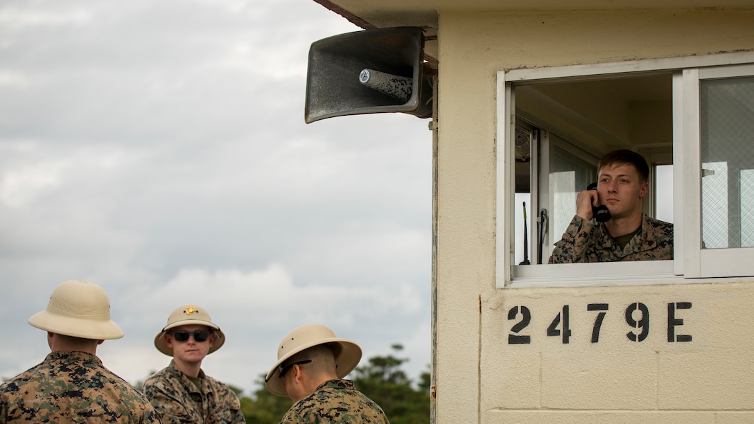 Sgt. Tyler R. Woelmer, announces commands to shooters on the firing line when to engage their targets during table two of the annual rifle range qualification, Jan. 12, 2017, at Camp Hansen, Okinawa, Japan. The Marine Corps revised table two of the marksmanship program October 2016 to increase marksmanship skill and realism in a combat environment. The Corps requires Marines to annually qualify at the range to determine their marksmanship skill. Woelmer, an Ida Township, Michigan, native, is a rifle range pit noncommissioned officer attached with 3d Reconnaissance Battalion, 3d Marine Division, III Marine Expeditionary Force. 
