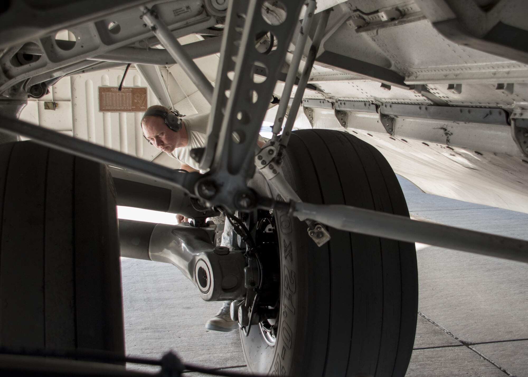 Tech. Sgt. Brian Maggard, a 5th Expeditionary Air Mobility Squadron aerospace maintenance craftsman, inspects the tires of a C-17 Globemaster III during a post-flight inspection at an undisclosed location in Southwest Asia Jan. 13, 2017. Tires usually wear out quickly on Globemasters as their missions often require landing on gravel or dirt runways in austere locations to deliver supplies and personnel. (U.S. Air Force photo/Senior Airman Andrew Park)