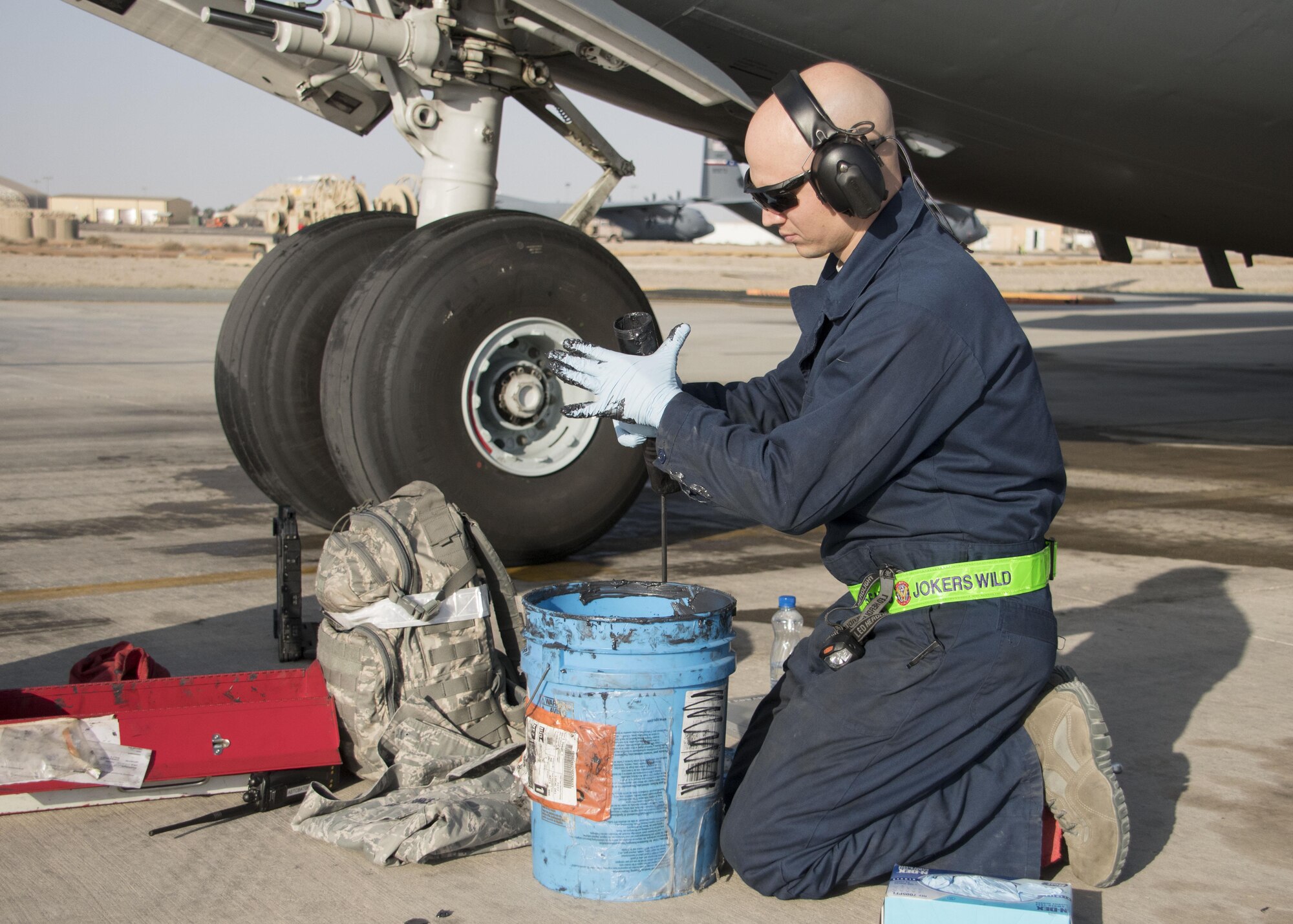 Tech. Sgt. Devon Edwards, a 5th Expeditionary Air Mobility Squadron aerospace maintenance craftsman, fills a grease gun at an undisclosed location in Southwest Asia Jan. 13, 2017. During post-flight inspections of the C-17 Globemaster IIIs, 5th EAMS Airmen grease approximately 200 points around the aircraft. (U.S. Air Force photo/Senior Airman Andrew Park)